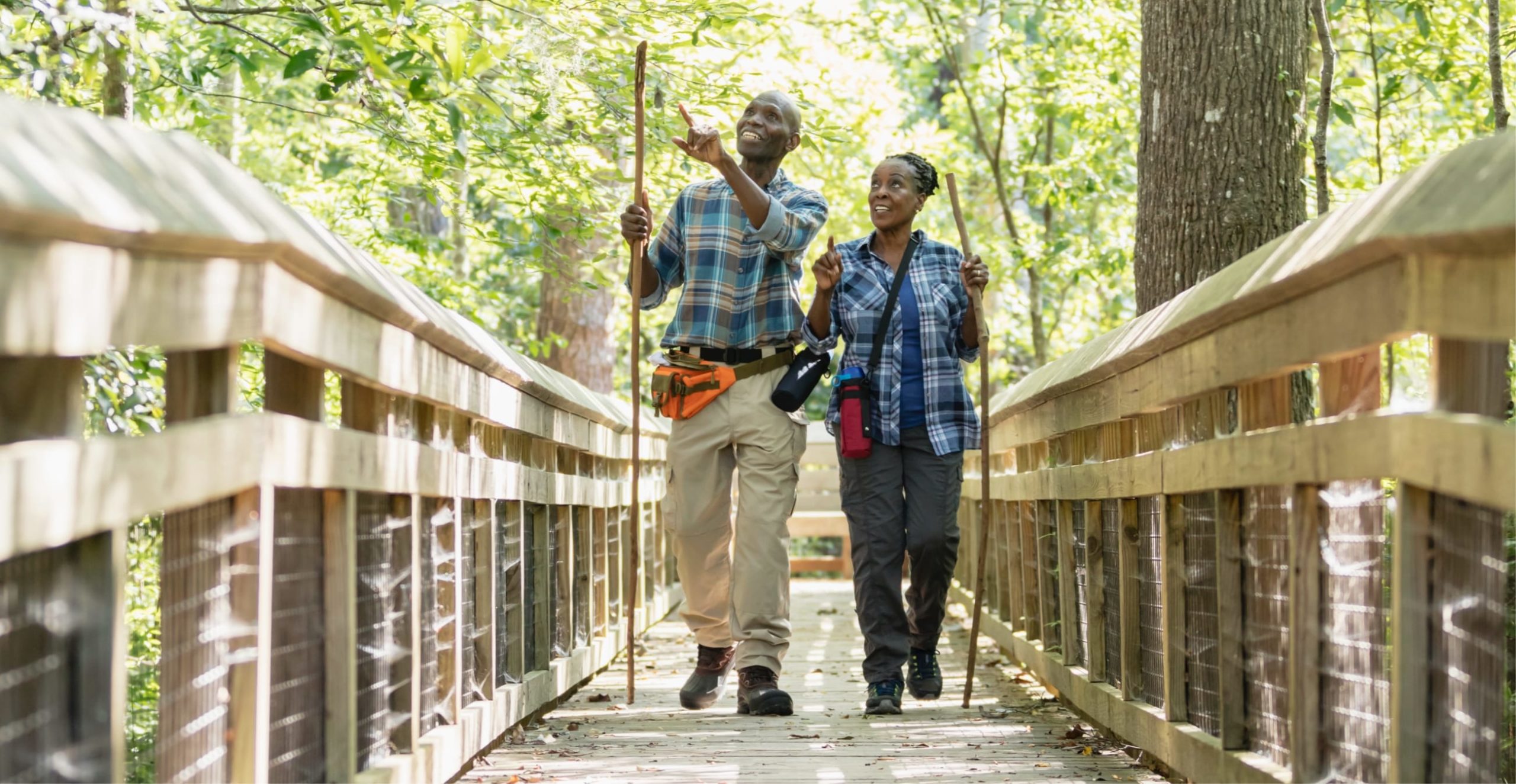 A 55+ years old couple walking along a path in nature in Sunbridge community, St. Cloud, Florida in Metro Orlando