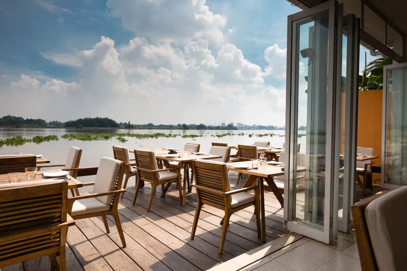 Tables and chairs placed outside on a marina overlooking the water in Sunbridge community, St. Cloud, Florida in Metro Orlando