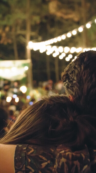 An image of a man with his arm wrapped around a girl while watching a lively concert in Sunbridge community, St. Cloud, Florida in Metro Orlando