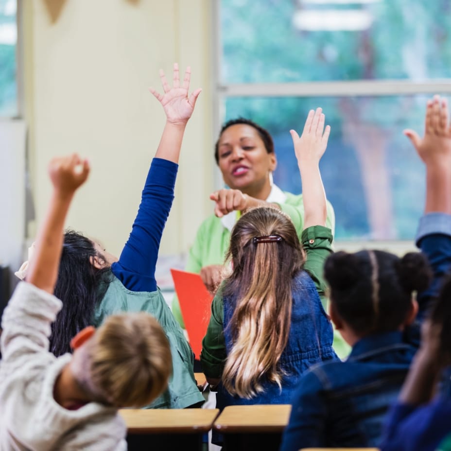 A classroom of children raising their hands in Sunbridge community, St. Cloud, Florida in Metro Orlando