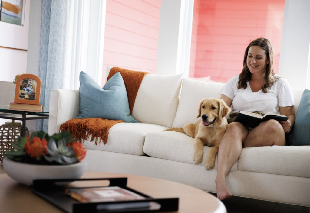 Interior view of a home with a woman and a dog on the couch